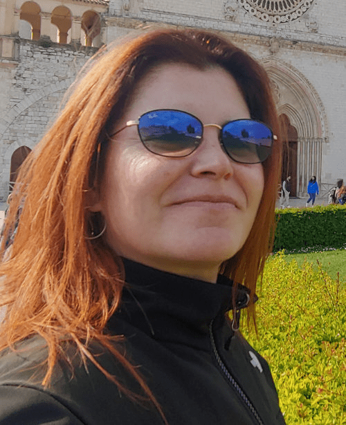 Portrait of Isabel Aracama, illustrator and designer, wearing sunglasses outdoors